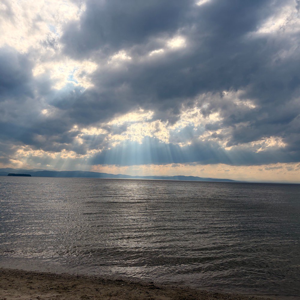 Sun through a break in storm clouds over Lake Champlain